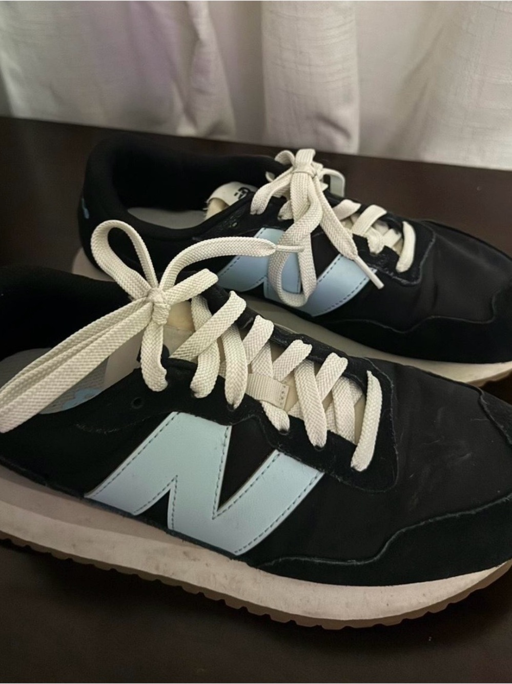 New Balance Women's Black Sneakers with Light Blue 'N' Logo and White Laces